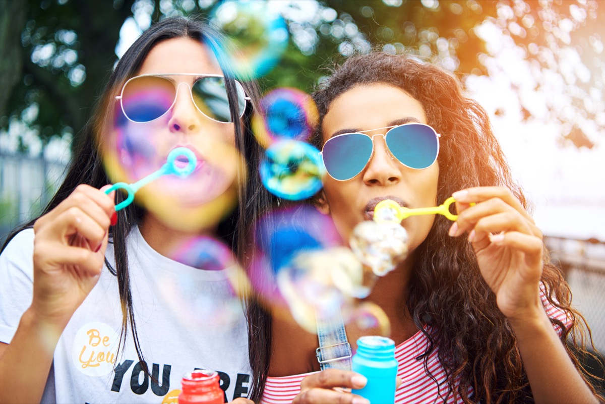 Two Young Women Blowing Bubbles
