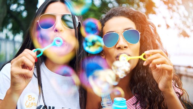 Two Young Women Blowing Bubbles