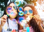 Two Young Women Blowing Bubbles