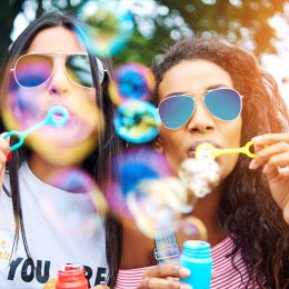 Two Young Women Blowing Bubbles