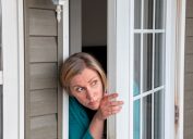 Woman Peering Out Her Window