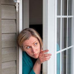 Woman Peering Out Her Window