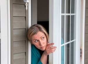 Woman Peering Out Her Window