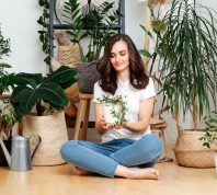 Woman Sitting on floor With Houseplants