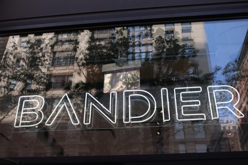 white neon Bandier sign in store window