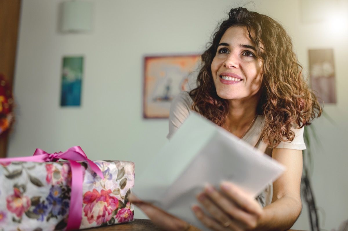 a woman opening up a birthday card