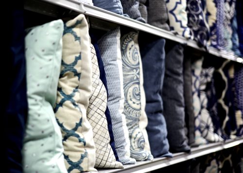 Row of decorative pillows on a store shelf