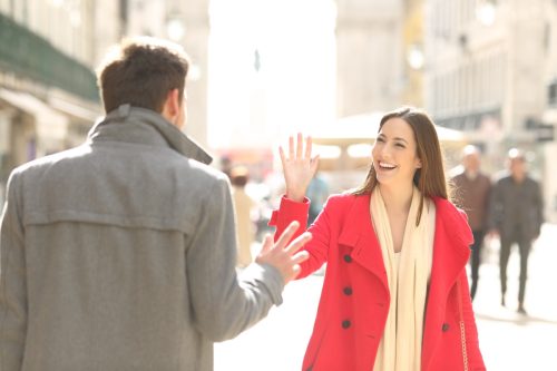 woman meets her friend on a city street and provides a funny response to "how are you"