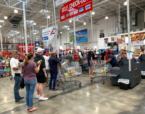 Customers standing on line to check out of Costco. Costco is an American corporation that operates a chain of members only warehouse clubs as seen on October 26, 2019.