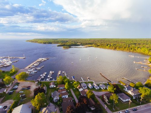 Aerial drone photography showing downtown Fish Creek and its marina, along with Peninsula State Park in Door County, Wisconsin