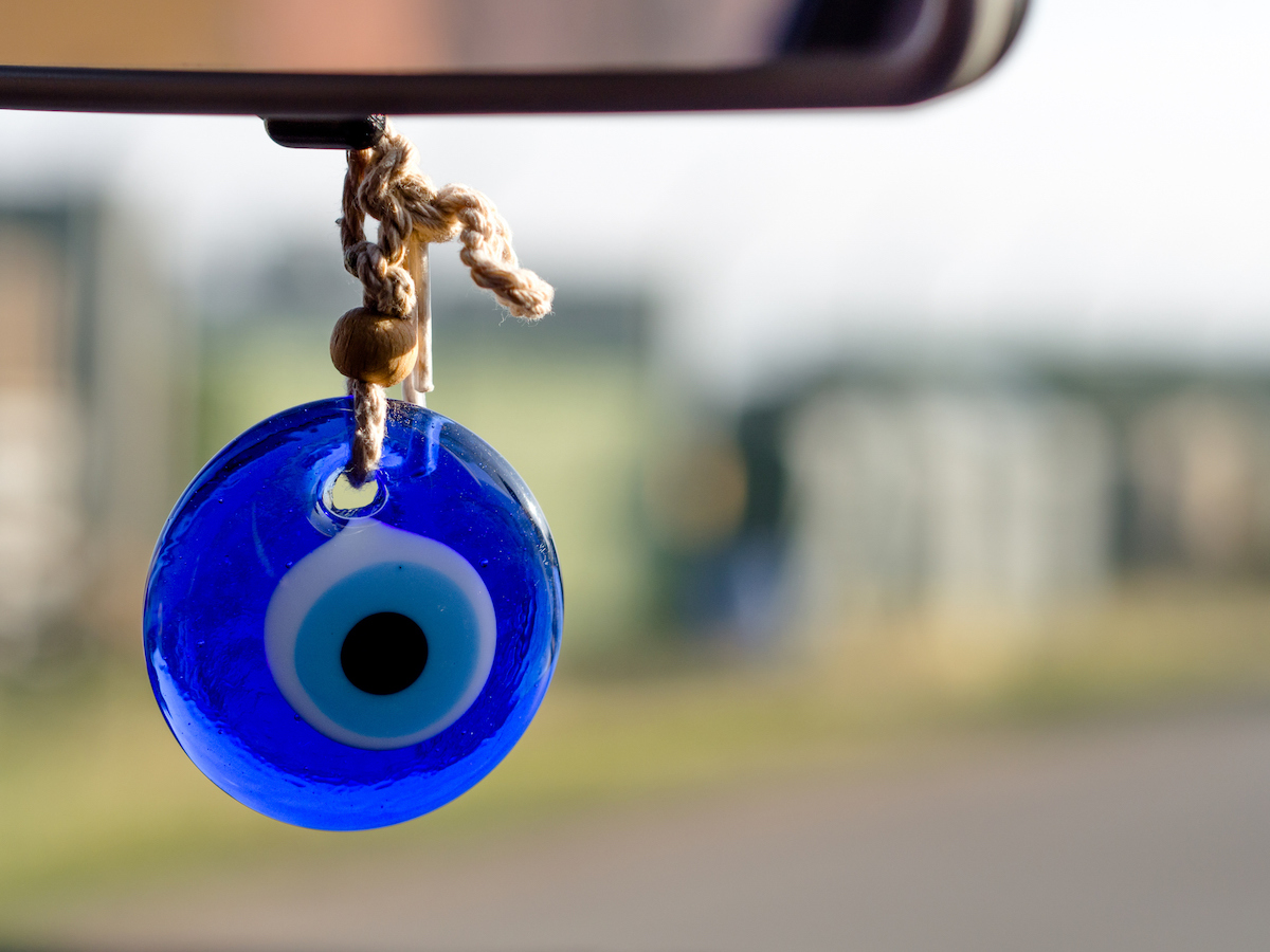 evil eye hanging from the rearview mirror in a car