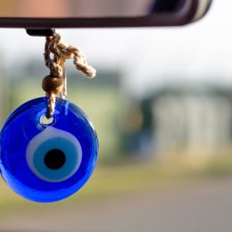 evil eye hanging from the rearview mirror in a car