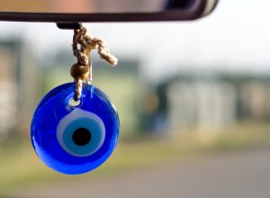 evil eye hanging from the rearview mirror in a car