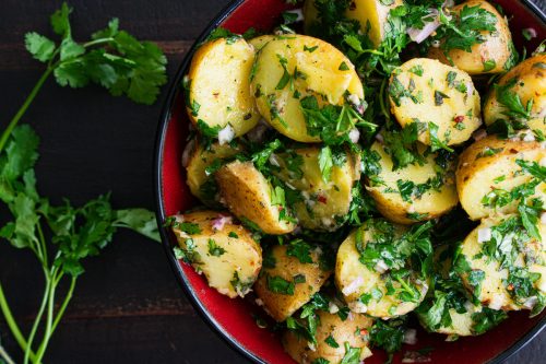A bowl of French potato salad with herbs