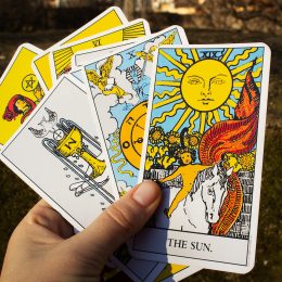 Hand holding a deck of tarot cards