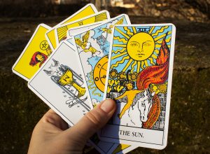 Hand holding a deck of tarot cards