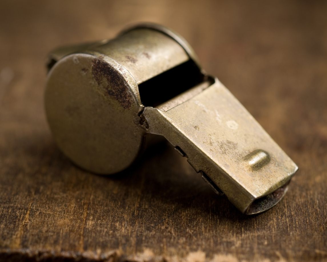 Old whistle on wooden desk