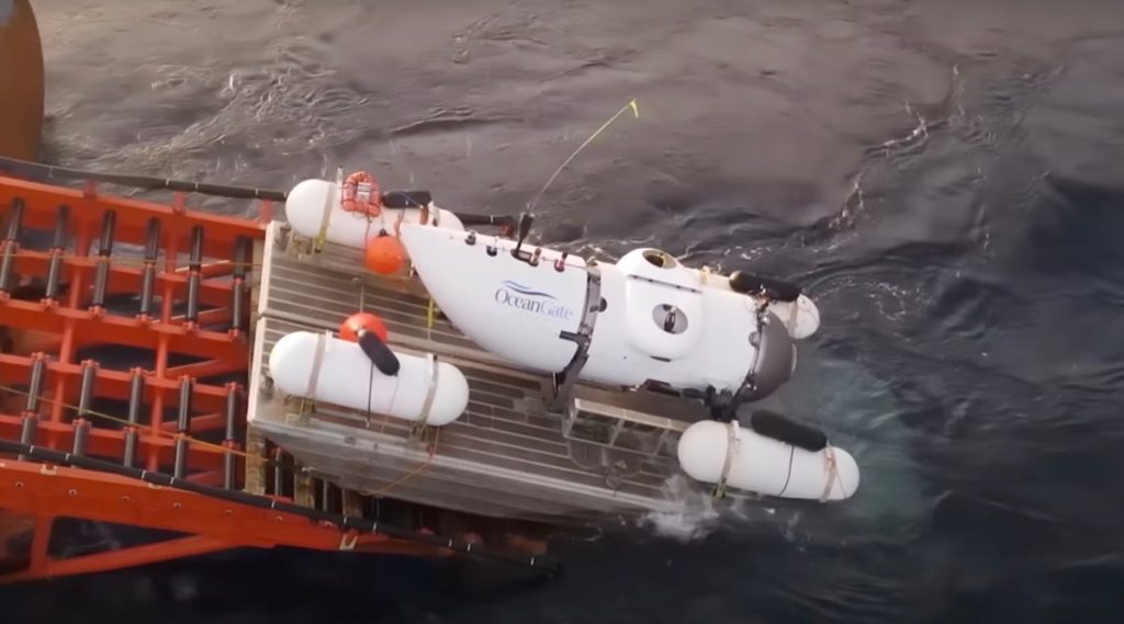 An overhead shot of the OceanGate submersible, Titan, sitting on a launch ramp of a support vessel