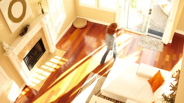 Blurred woman walking through modern living room from above