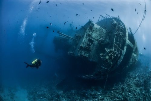 Divers exploring the shipwreck in the Jordan Red Sea