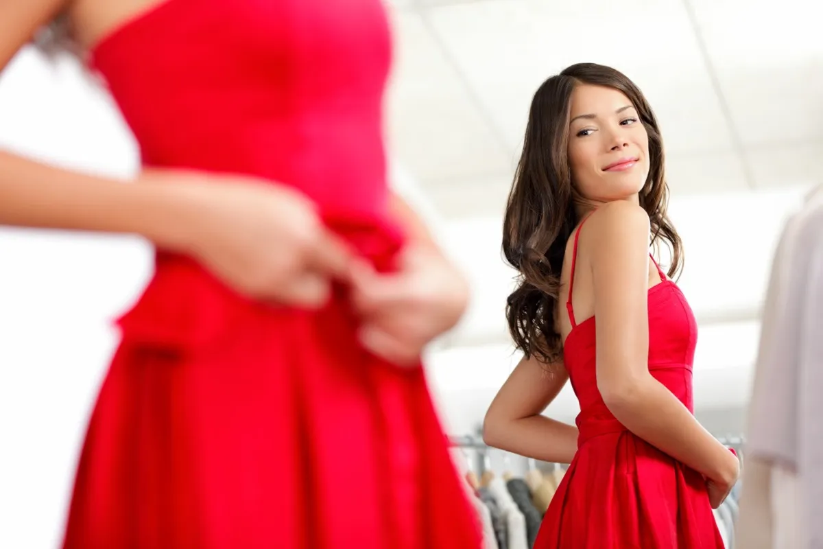 woman trying on red dress