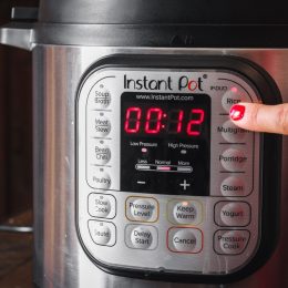 woman turning on instant pot