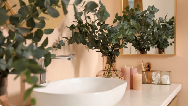 Bathroom sink with candles and eucalyptus