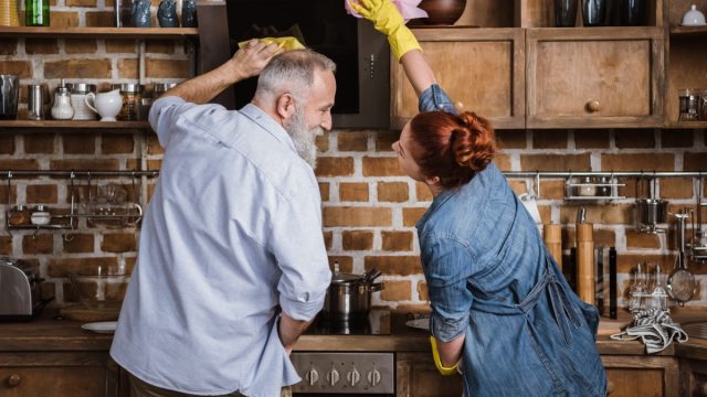 older couple cleaning kitchen