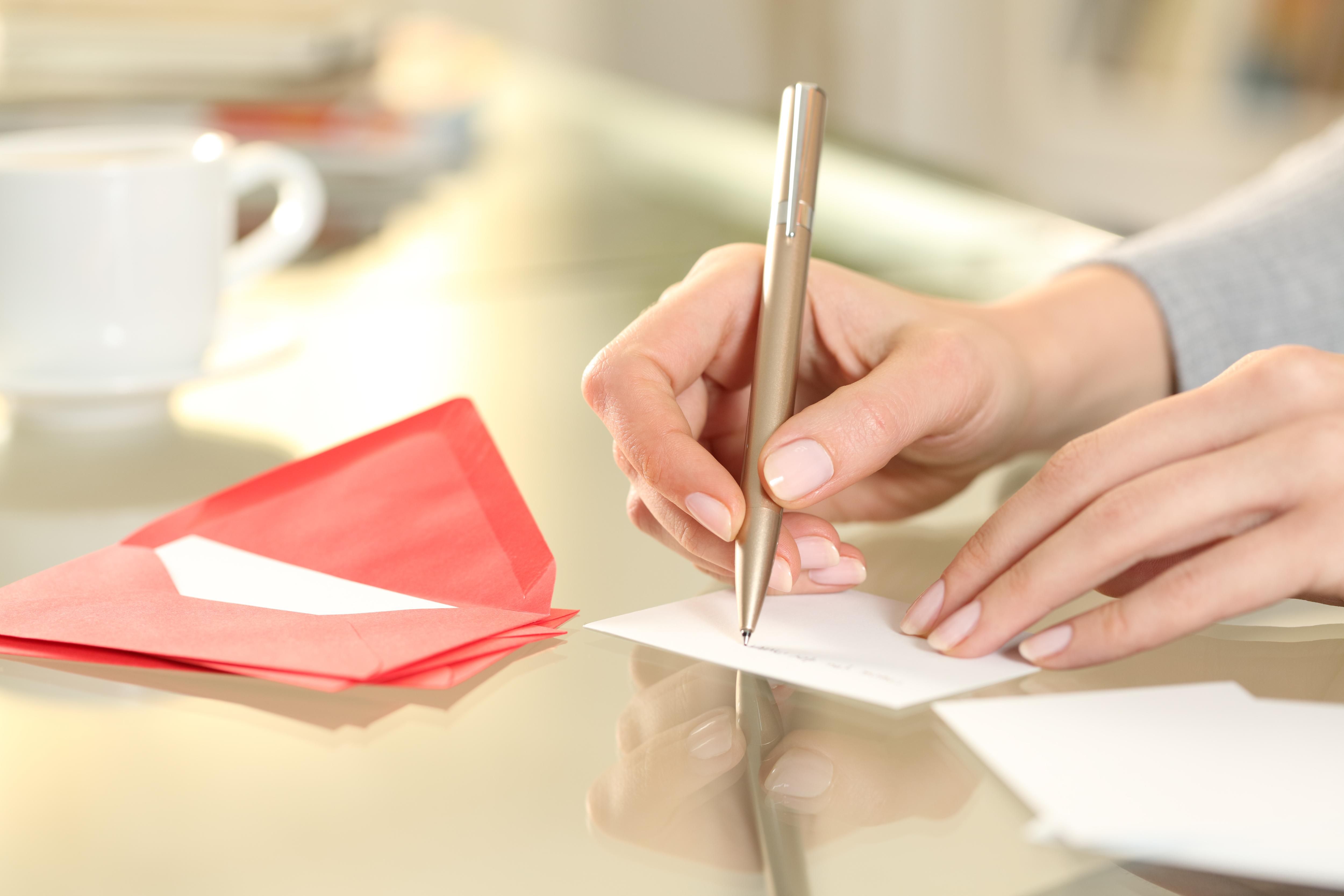 Close,Up,Of,Woman,Hand,Writing,Greeting,Thank,You,Card