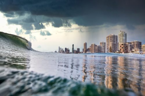 Tsunami king tide, dark stormy sky and rain approach the buildings of Surfers paradise