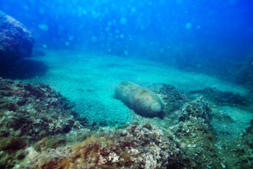 Photo of bomb rusty wreck laying on the sea floor