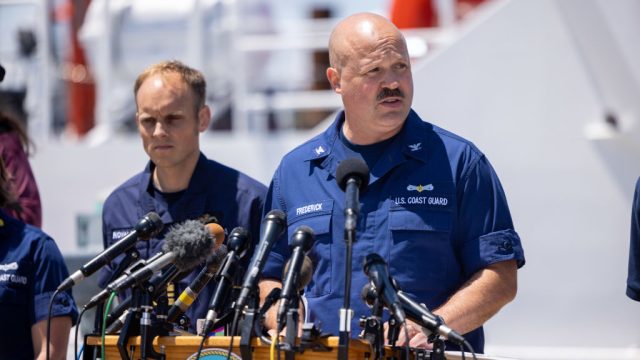 Capt. Jamie Frederick of the U.S. Coast Guard, joined by others from the U.S. Navy, Royal Navy and Woods Hole Oceanographic Institute, gives an update on the search efforts for five people aboard a missing submersible approximately 900 miles off Cape Cod, on June 21, 2023 in Boston, Massachusetts.