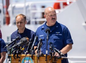Capt. Jamie Frederick of the U.S. Coast Guard, joined by others from the U.S. Navy, Royal Navy and Woods Hole Oceanographic Institute, gives an update on the search efforts for five people aboard a missing submersible approximately 900 miles off Cape Cod, on June 21, 2023 in Boston, Massachusetts.