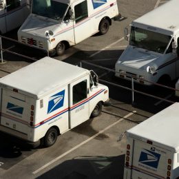 A USPS (United States Postal Service) mail truck parks for the evening.