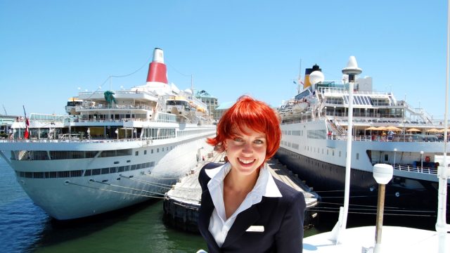Cruise Staff Member in Front Of Ship