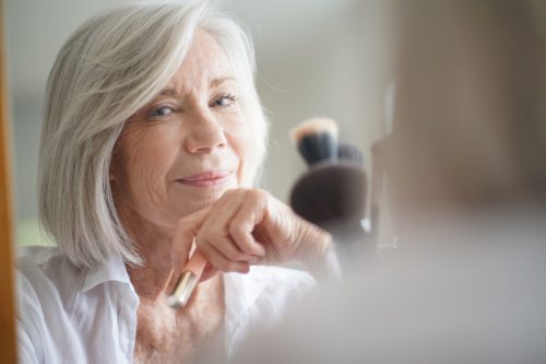 Gray Haired Woman Looking in a Mirror