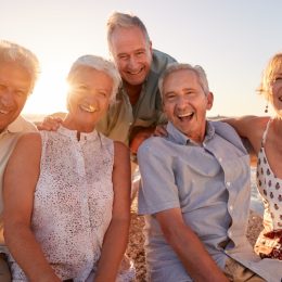 Group of Senior Friends Hanging Out on the Beach
