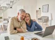 Happy Older Couple Using Laptop