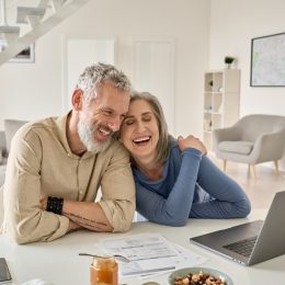Happy Older Couple Using Laptop