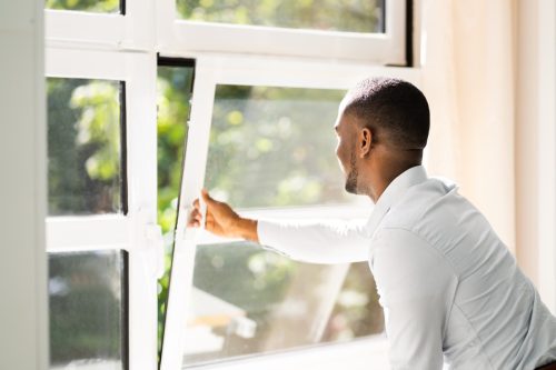Man Opening a Window