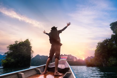 Man with Arms Raised on a Boat