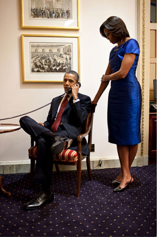 President Obama and Michelle Obama making a call in the White House