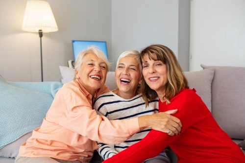 Three Older Ladies Hugging on the Couch