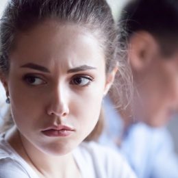 Close up of pretty sad woman feel upset after family fight, spouses avoid talking after disagreement, offended wife angry having dispute or misunderstanding with husband, mad spouses ignore each other