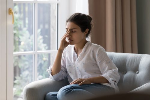Woman Overthinking on Couch