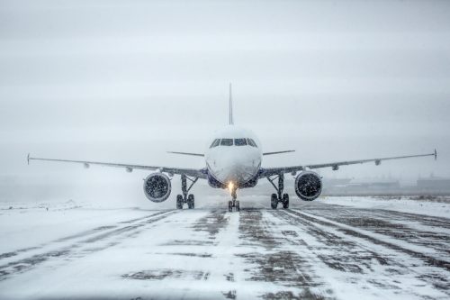 Airliner on runway in blizzard.