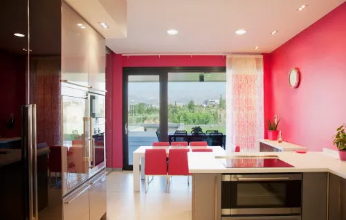 Modern kitchen with bright pink walls