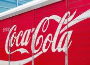 A Coca-Cola logo on the side of a delivery truck