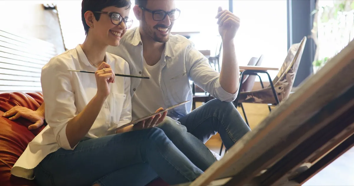 man and woman attending a painting workshop together for their first date