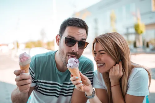 Man and woman sharing ice cream